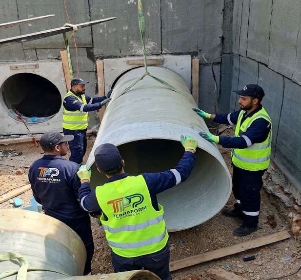 Guiding a large-bore GRP pipe through a wall penetration